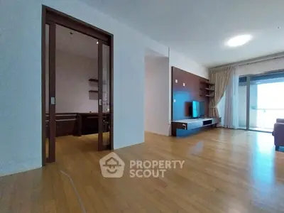 Spacious living room with wooden flooring and modern entertainment unit
