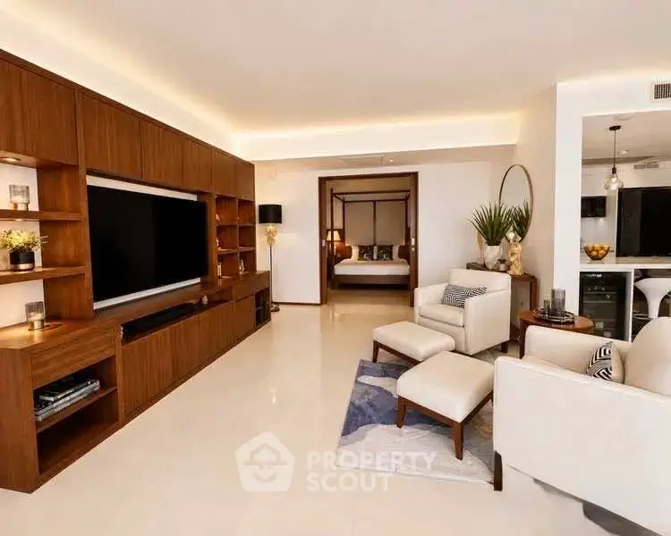 Luxurious living room with modern furniture and open layout leading to a stylish bedroom.