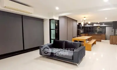Modern open-plan living room with sleek kitchen and stylish furniture