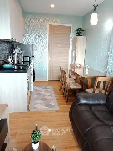 Modern open-layout kitchen and dining area with stylish decor and cozy seating.