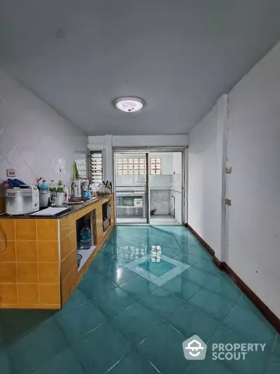 Spacious kitchen with vibrant blue tiles and ample counter space