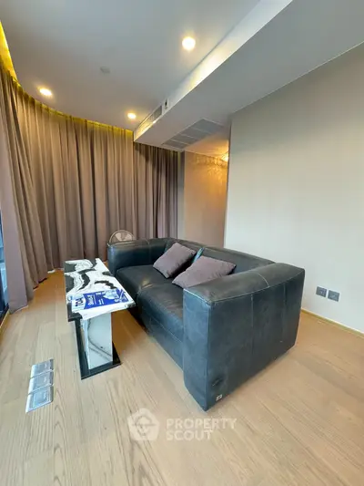 Modern living room with sleek black sofa and elegant decor