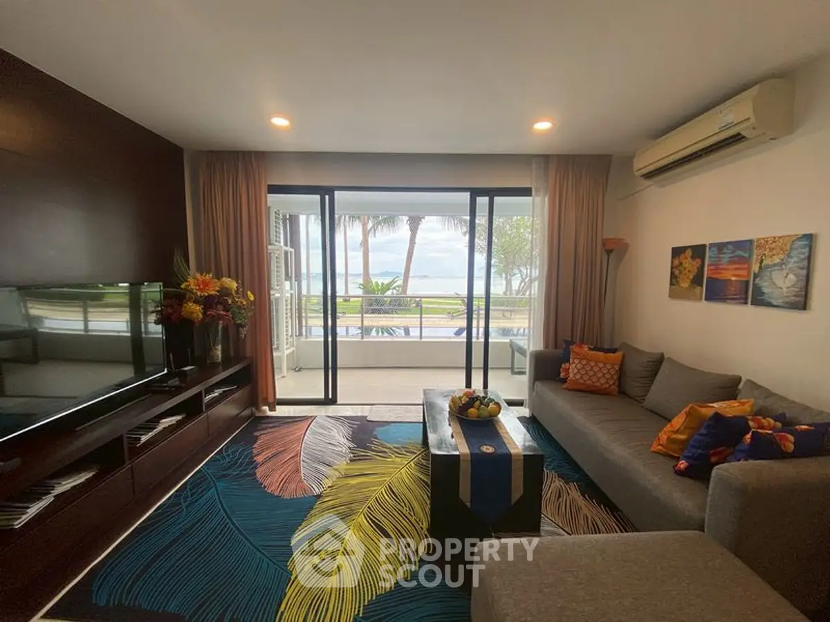 Stylish living room with ocean view, modern decor, and vibrant accents.