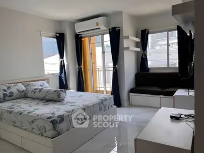 Modern bedroom with balcony access and stylish decor in urban apartment