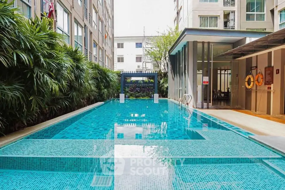 Luxurious condominium pool area with modern design and lush greenery