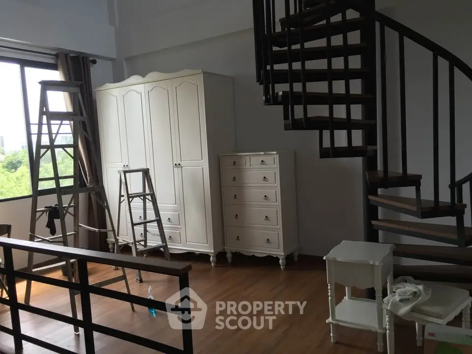 Spacious interior with spiral staircase and elegant furniture, ideal for modern living.