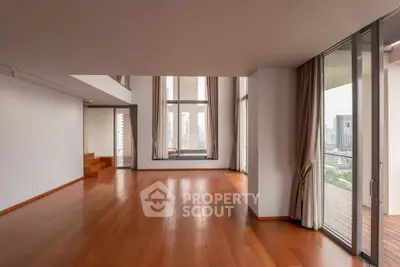 Spacious modern living room with floor-to-ceiling windows and city view