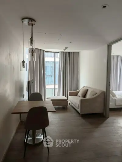 Modern living room with cozy sofa and dining area in a stylish apartment.