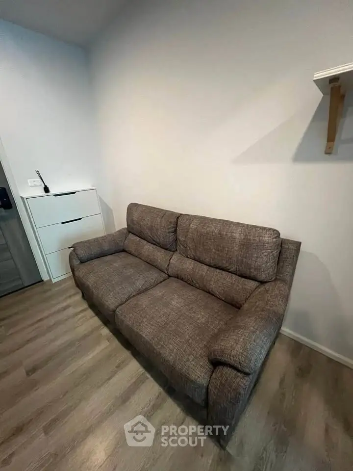 Cozy living room with a comfortable brown sofa and modern decor.