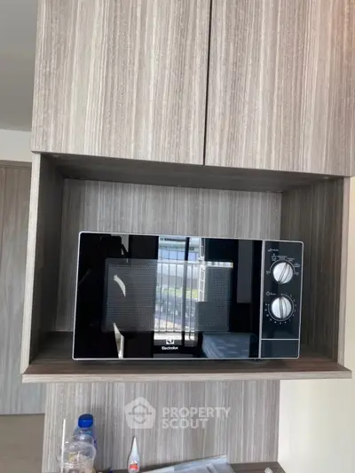 Modern kitchen with sleek built-in oven and stylish shelving