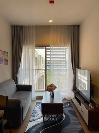 Cozy living room with modern decor, large window, and stylish furniture, perfect for relaxation and entertainment.
