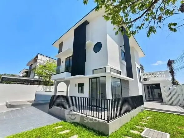 Modern three-story house with sleek design and spacious outdoor area, perfect for contemporary living.