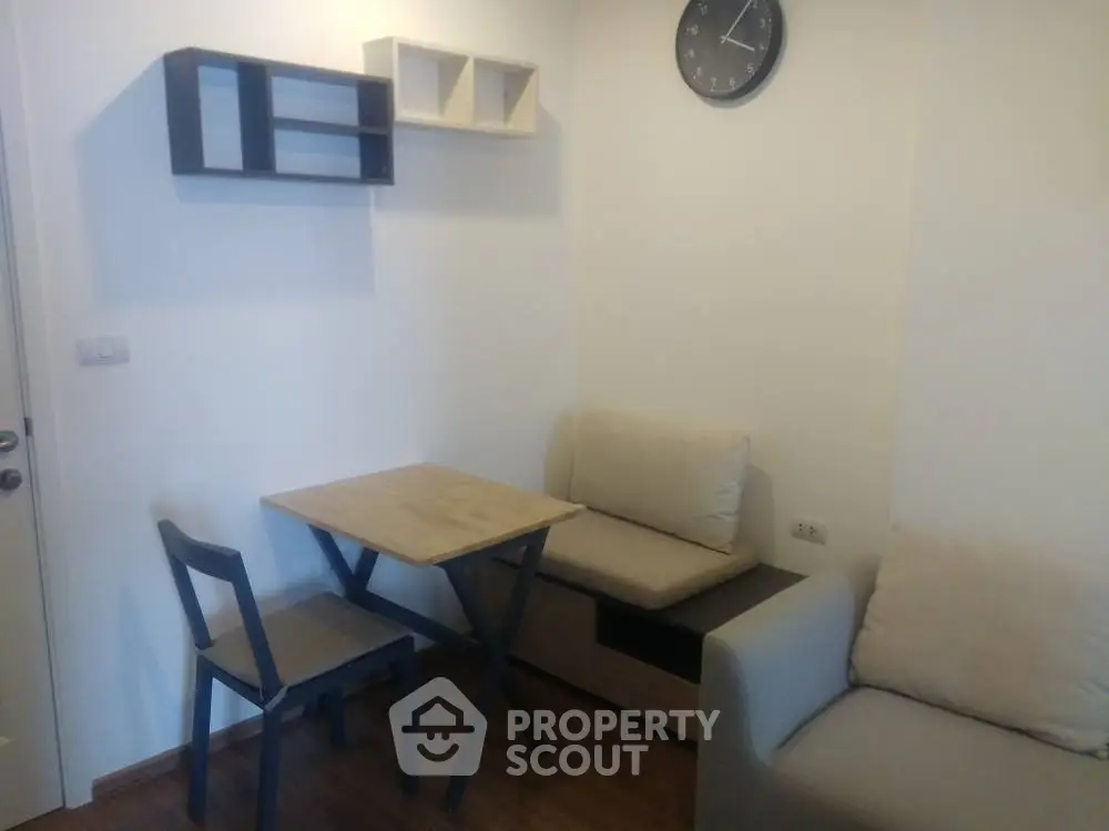 Cozy living room with minimalist furniture and wall clock