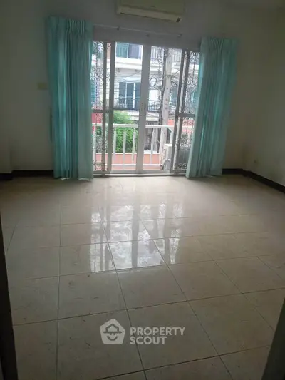 Spacious room with large windows and balcony view in a modern apartment.