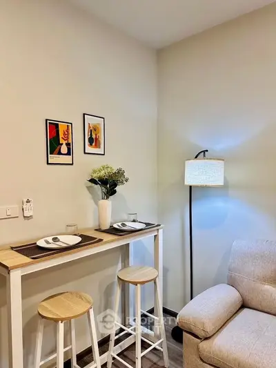 Cozy living room with modern decor and dining area in a stylish apartment.