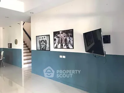 Modern interior with stylish wall art and mounted TV in a spacious living area.