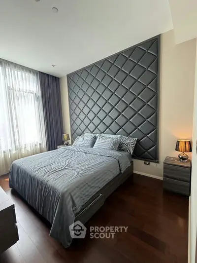 Luxurious bedroom with elegant padded wall and modern decor