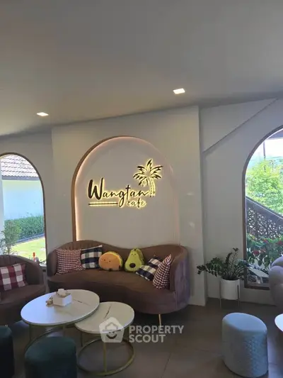 Charming cafe interior with cozy seating and stylish decor, perfect for relaxation and socializing.