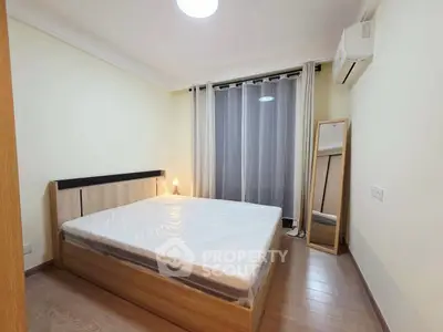 Spacious bedroom with modern decor and natural light