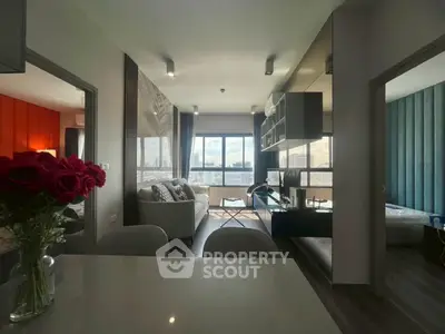 Modern living room with city view, stylish decor, and open layout in high-rise apartment.