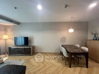 Modern living room with stylish dining area and elegant lighting