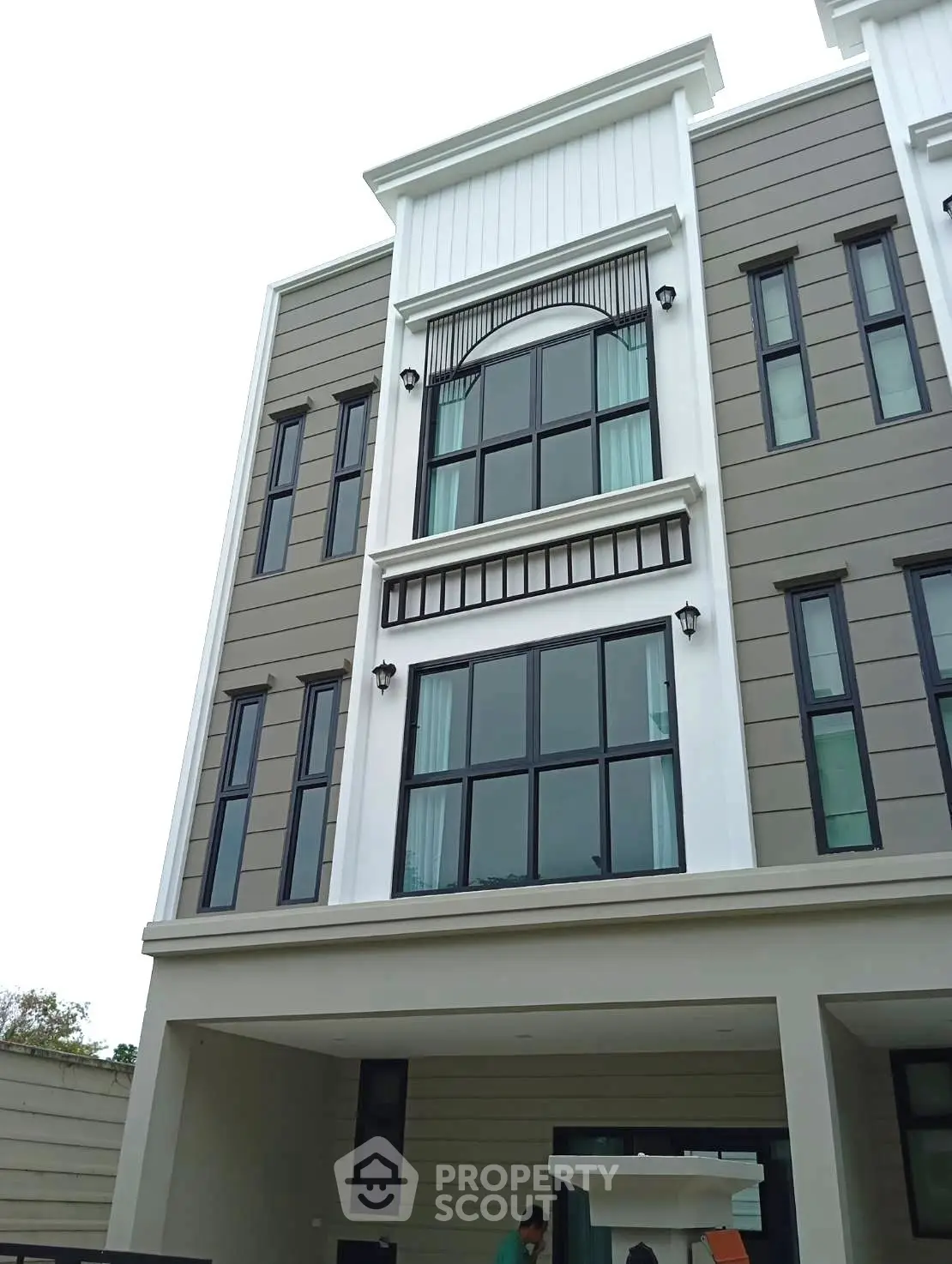 Modern multi-story building with large windows and stylish facade