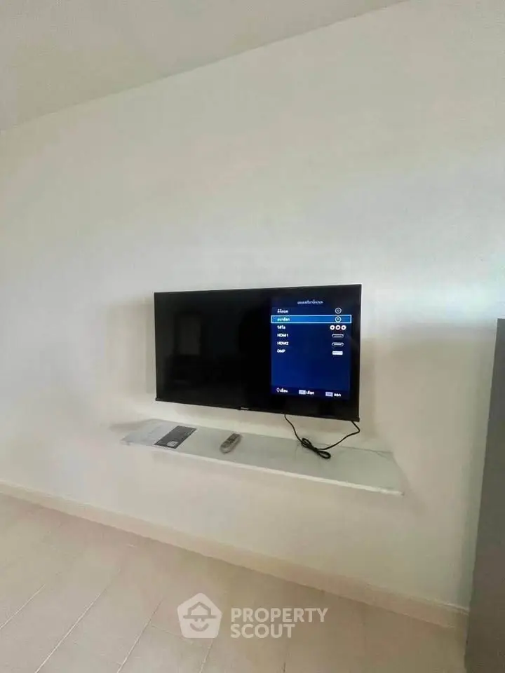 Modern living room with wall-mounted TV and minimalist decor