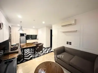 Modern living room with stylish furniture and open kitchen layout