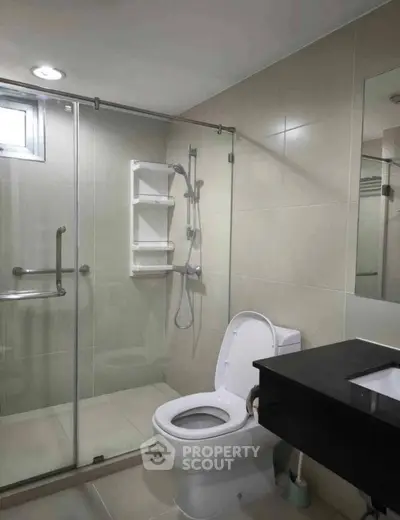 Modern bathroom with glass shower and sleek fixtures