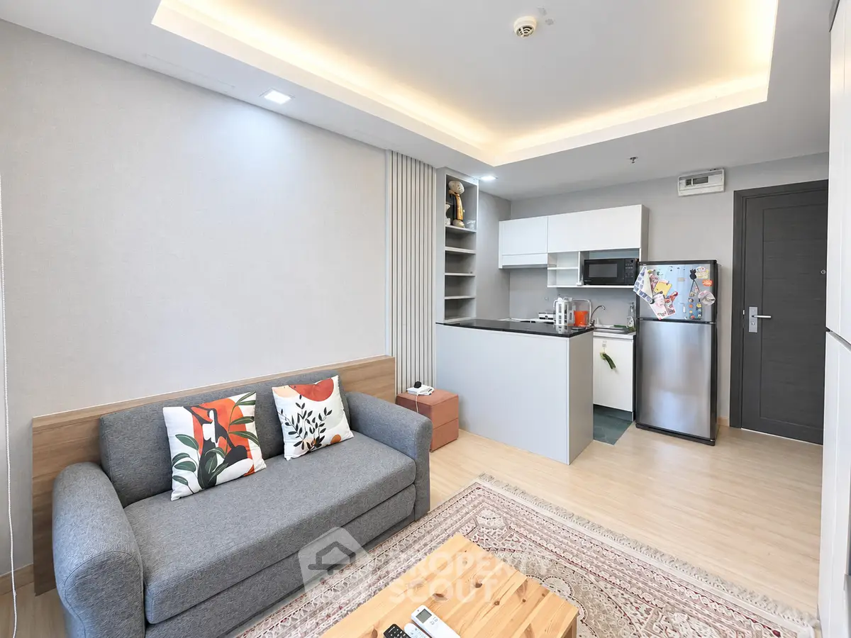 Modern living room with open kitchen and stylish decor in a cozy apartment.