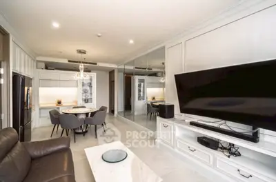 Modern living room with sleek design, large TV, and dining area in open layout.