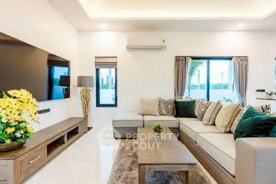 Luxurious modern living room with stylish decor and large sectional sofa, perfect for relaxation and entertainment.
