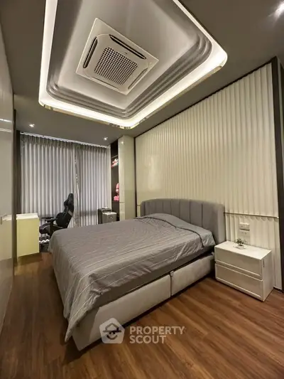 Modern bedroom with stylish ceiling design and cozy ambiance