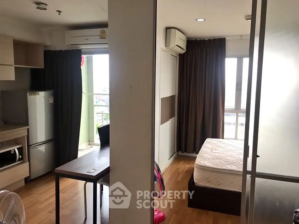 Cozy studio apartment with modern kitchen and bright bedroom area