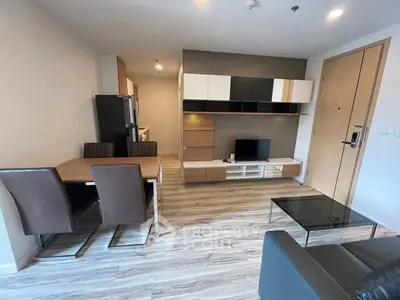 Modern living room with stylish furniture and open kitchen layout