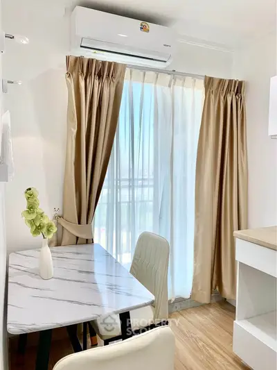 Chic dining nook with marble table and elegant curtains in modern apartment