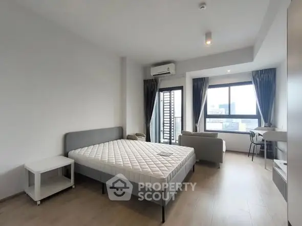 Spacious modern bedroom with city view and natural light