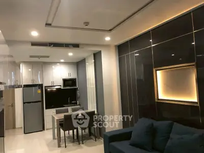 Modern open-plan kitchen and living area with sleek design and ambient lighting.