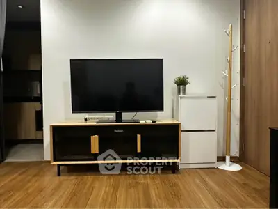 Modern living room with sleek TV stand and wooden flooring