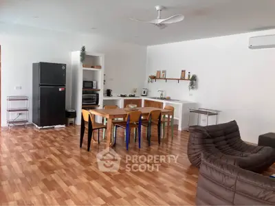 Spacious open-plan kitchen and dining area with modern appliances and stylish furniture.