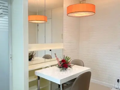 Modern dining area with stylish lighting and floral centerpiece