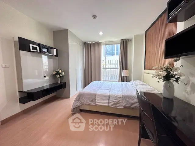 Modern bedroom with elegant decor, featuring a cozy bed, stylish furniture, and ample natural light.