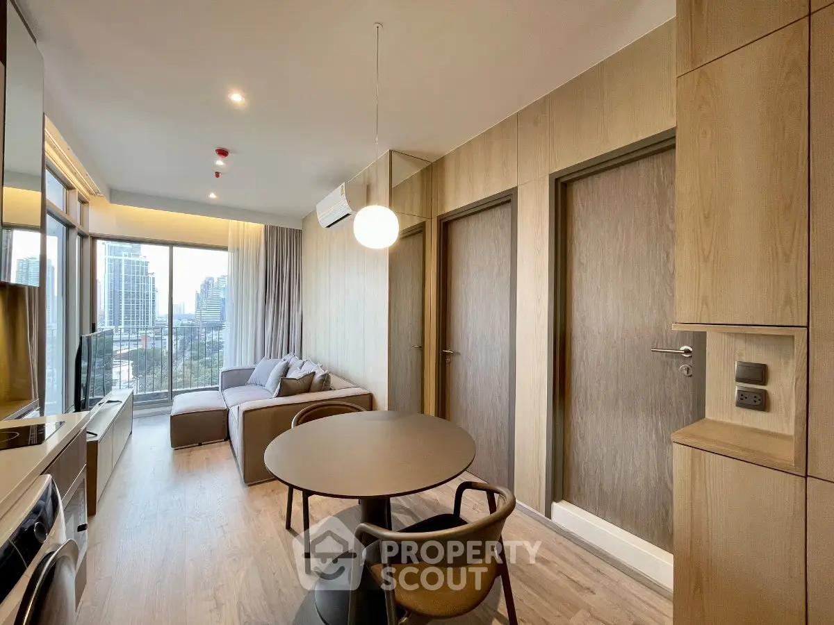 Modern living room with city view, featuring sleek furniture and wooden accents, perfect for urban living.