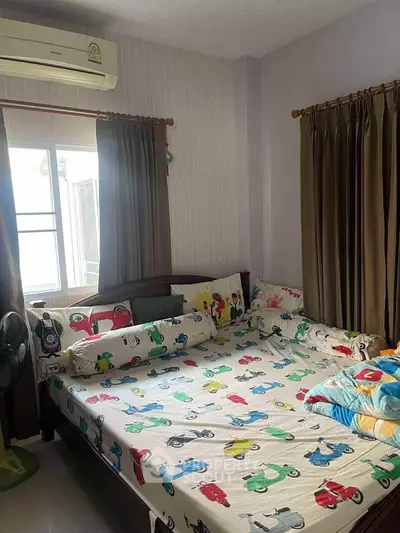 Cozy bedroom with colorful scooter-themed bedding and natural light