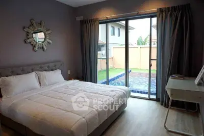 Spacious bedroom with pool view and modern decor in a luxury home