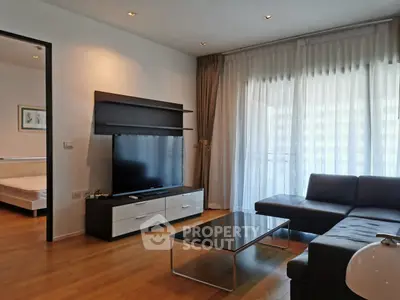 Modern living room with sleek furniture and large window for natural light.