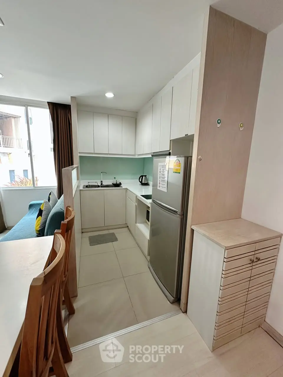 Modern compact kitchen with sleek cabinets and cozy dining area