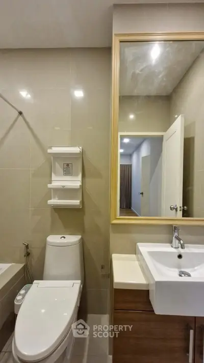 Modern bathroom with sleek fixtures and large mirror