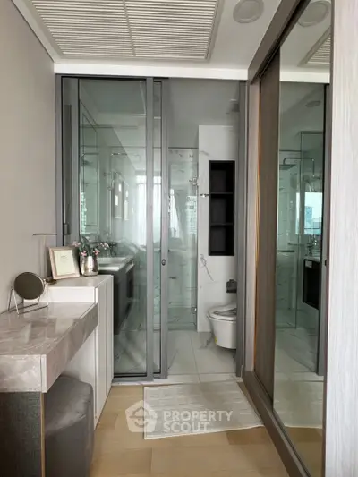 Modern bathroom with glass shower and elegant vanity in luxury apartment