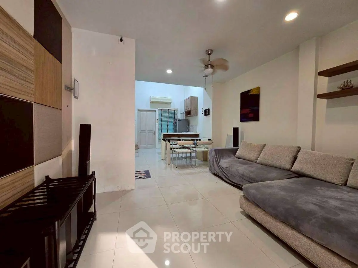 Spacious living room with modern decor and open kitchen layout